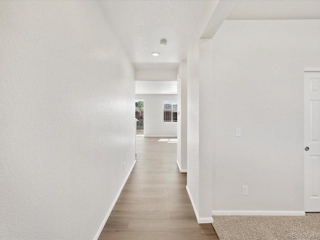 8850 Sedalia St, Commerce City, CO 80022 - corridor featuring baseboards and wood finished floors