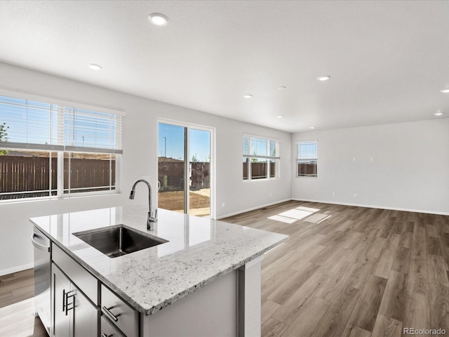 8850 Sedalia St, Commerce City, CO 80022 - kitchen featuring a sink, dishwasher, light wood-type flooring, baseboards, and recessed lighting