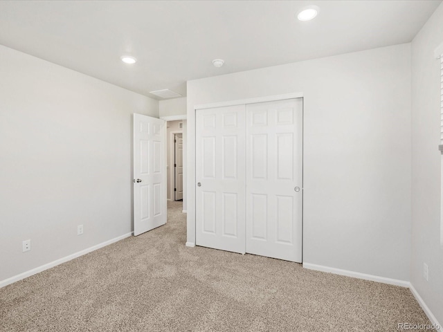 8850 Sedalia St, Commerce City, CO 80022 - unfurnished bedroom featuring light colored carpet, baseboards, a closet, and recessed lighting