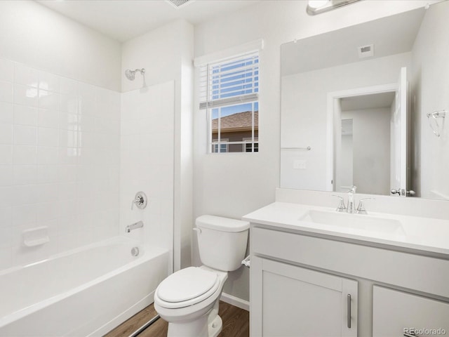 8850 Sedalia St, Commerce City, CO 80022 - bathroom featuring toilet, wood finished floors, vanity, shower / bath combination, and baseboards