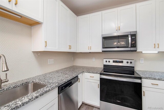 kitchen with white cabinetry, appliances with stainless steel finishes, and sink