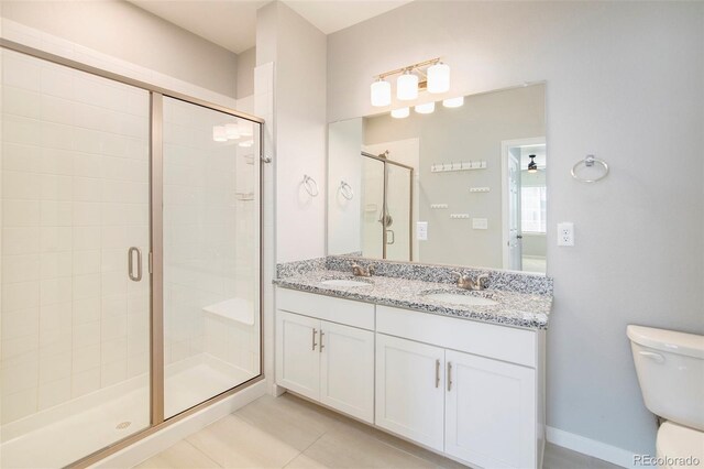 bathroom with vanity, toilet, walk in shower, and tile patterned flooring