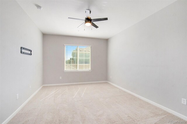 empty room featuring light carpet and ceiling fan