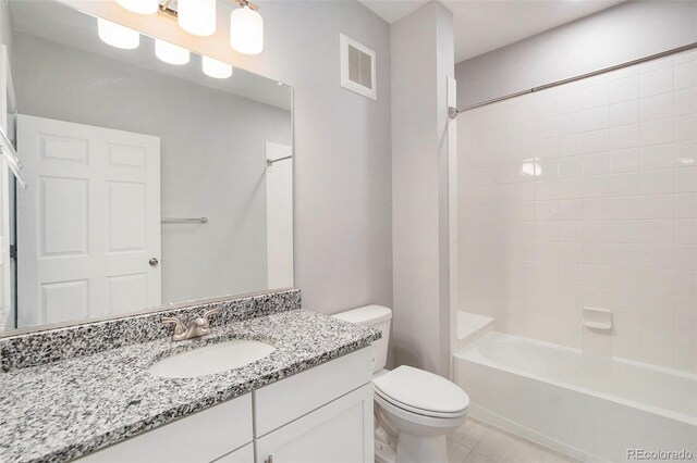 full bathroom featuring toilet, vanity, tile patterned floors, and shower / bathtub combination