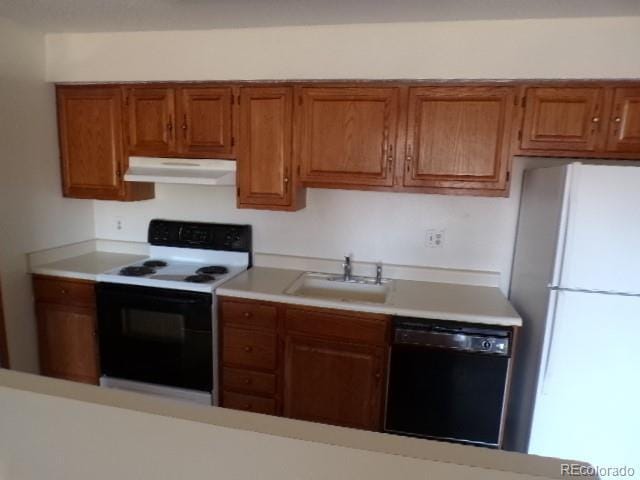 12043 W Cross Dr Unit 201, Littleton, CO 80127 - kitchen featuring electric stove, black dishwasher, under cabinet range hood, freestanding refrigerator, and a sink