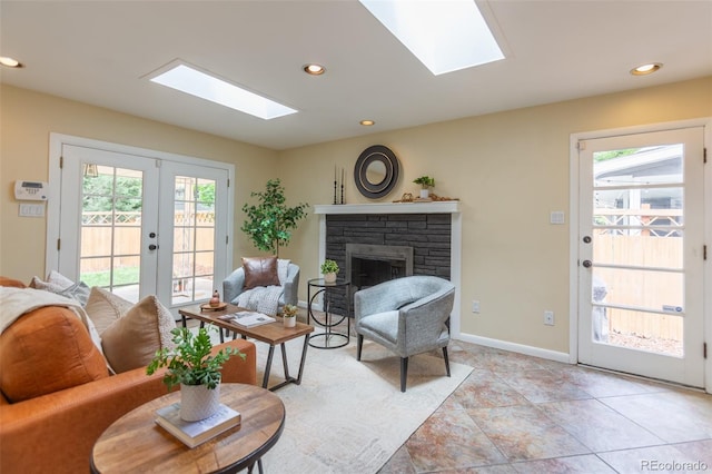 3098 S Vine St, Denver, CO 80210 - living room with a skylight, a stone fireplace, french doors, recessed lighting, and baseboards