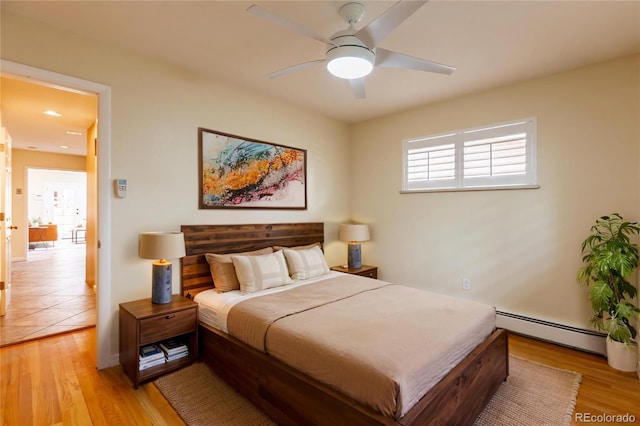 3098 S Vine St, Denver, CO 80210 - bedroom with a baseboard heating unit, light wood finished floors, and ceiling fan