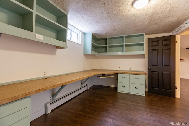 3098 S Vine St, Denver, CO 80210 - unfurnished office featuring baseboard heating, built in study area, dark wood finished floors, and baseboards