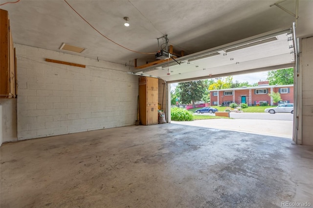 3098 S Vine St, Denver, CO 80210 - garage featuring a garage door opener and concrete block wall