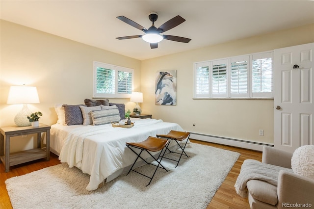 3098 S Vine St, Denver, CO 80210 - bedroom featuring a baseboard radiator, wood finished floors, and a ceiling fan