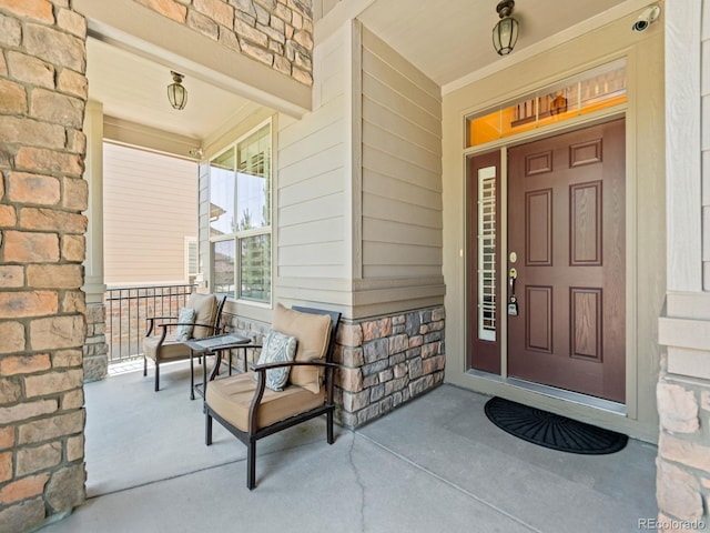 13645 Osage Ct, Broomfield, CO 80023 - property entrance with covered porch, stone siding, and a security system