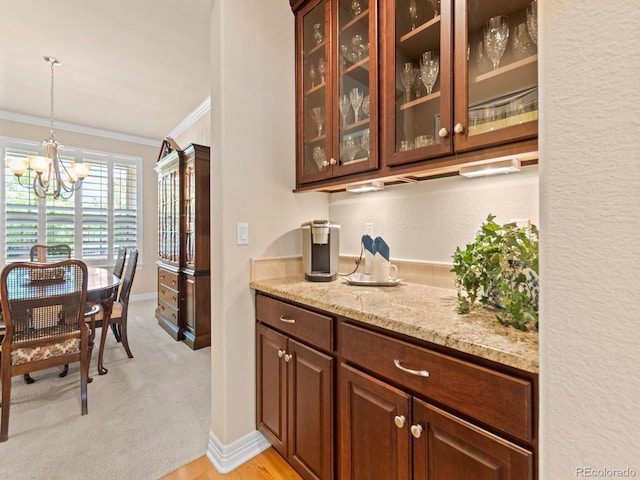 13645 Osage Ct, Broomfield, CO 80023 - bar featuring ornamental molding, a chandelier, and hanging light fixtures