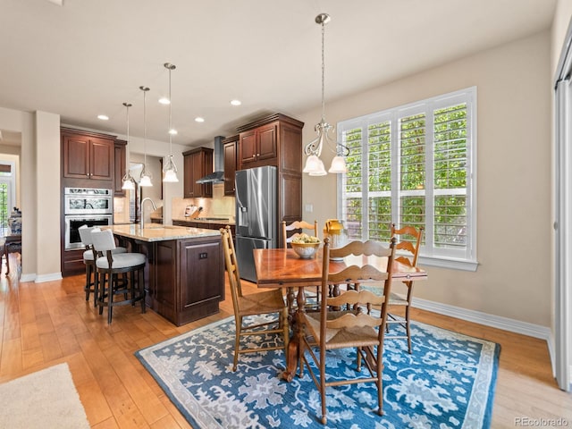 13645 Osage Ct, Broomfield, CO 80023 - dining space featuring light wood-type flooring and recessed lighting