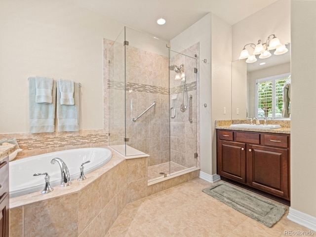 13645 Osage Ct, Broomfield, CO 80023 - bathroom with vanity, a garden tub, a shower stall, and tile patterned floors