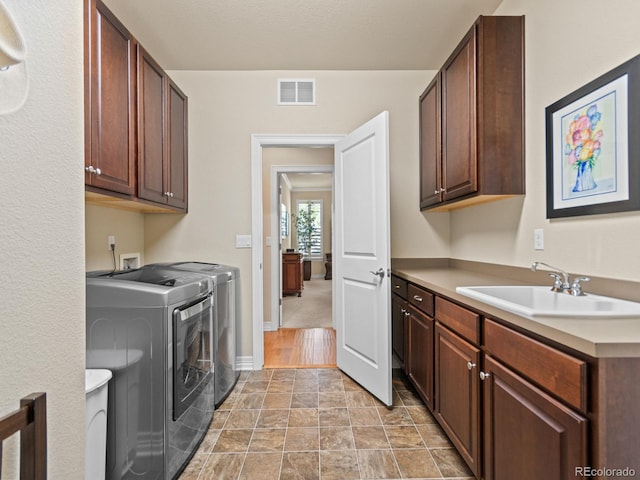 13645 Osage Ct, Broomfield, CO 80023 - washroom with cabinet space and washing machine and dryer