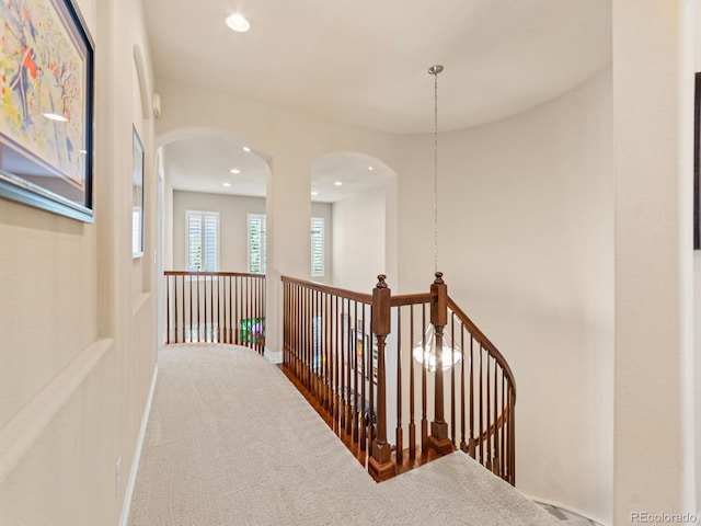 13645 Osage Ct, Broomfield, CO 80023 - hallway featuring carpet, arched walkways, an upstairs landing, and recessed lighting