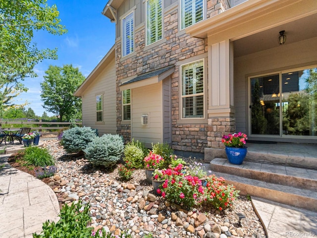13645 Osage Ct, Broomfield, CO 80023 - doorway to property with stone siding and a patio area