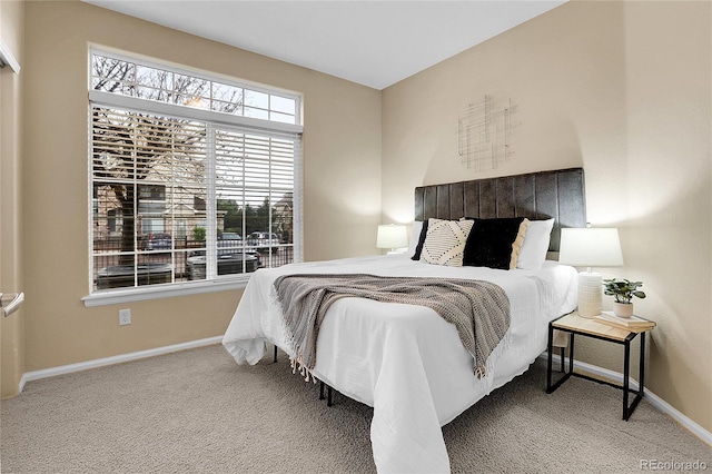 carpeted bedroom featuring baseboards