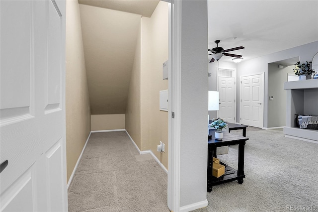 hall featuring carpet flooring and baseboards