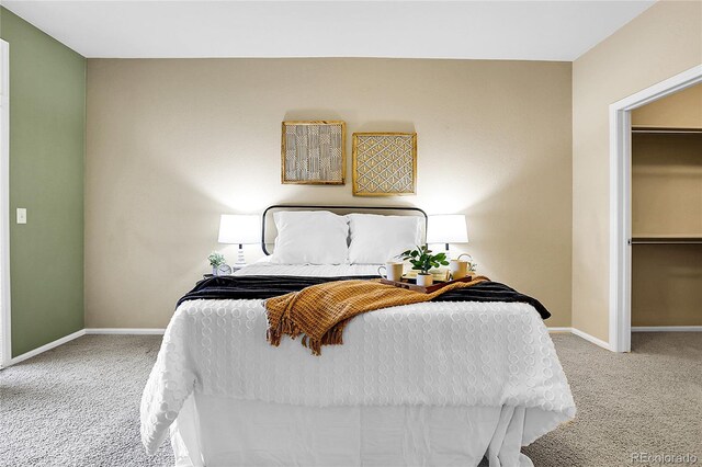 carpeted bedroom featuring baseboards