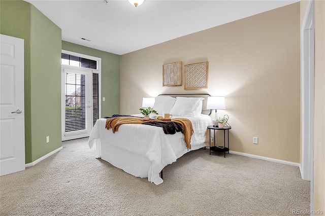 carpeted bedroom featuring access to exterior and baseboards