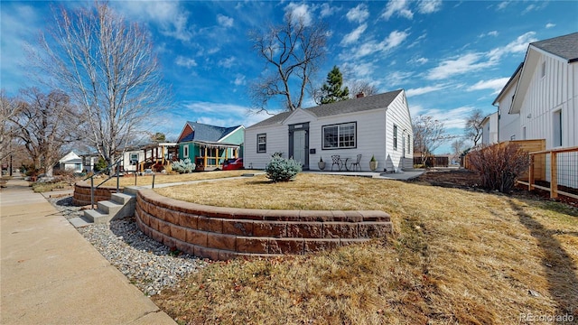 bungalow featuring a residential view, fence, and a front yard