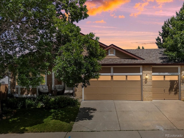 885 Sage Sparrow Cir, Highlands Ranch, CO 80129 - view of front facade featuring brick siding, driveway, a front lawn, and roof with shingles