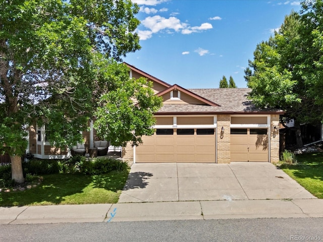 885 Sage Sparrow Cir, Highlands Ranch, CO 80129 - view of front of property featuring concrete driveway, brick siding, a garage, and a front yard