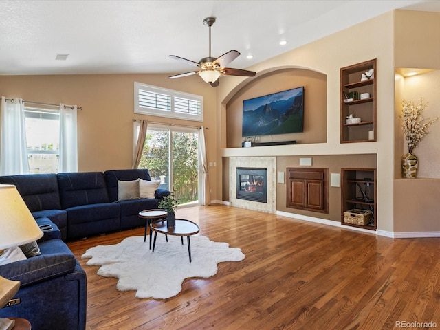 885 Sage Sparrow Cir, Highlands Ranch, CO 80129 - living area featuring healthy amount of natural light, wood finished floors, a tile fireplace, recessed lighting, and lofted ceiling