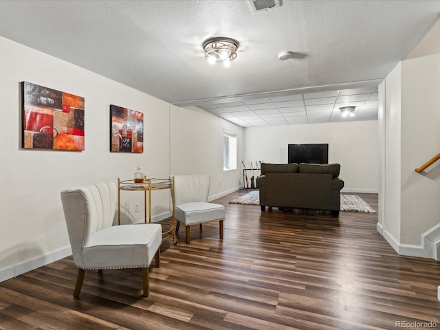 885 Sage Sparrow Cir, Highlands Ranch, CO 80129 - living area with dark wood finished floors, a paneled ceiling, and a textured ceiling