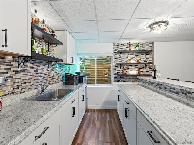 885 Sage Sparrow Cir, Highlands Ranch, CO 80129 - kitchen featuring open shelves, a drop ceiling, dark wood-style floors, tasteful backsplash, and white cabinets