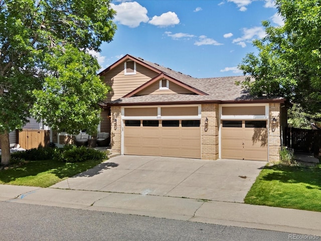 885 Sage Sparrow Cir, Highlands Ranch, CO 80129 - view of front of house with driveway, brick siding, a garage, and roof with shingles