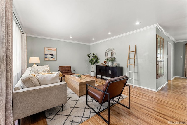 living room with a healthy amount of sunlight, light hardwood / wood-style floors, crown molding, and french doors