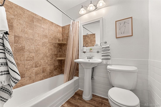 bathroom featuring toilet, shower / bath combo with shower curtain, and wood-type flooring