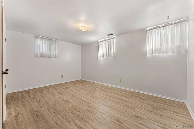 empty room featuring a wealth of natural light and light wood-type flooring