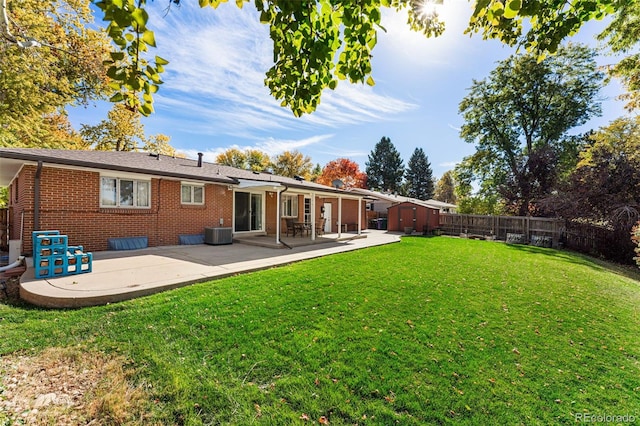 back of house featuring a yard, a patio area, and central AC unit