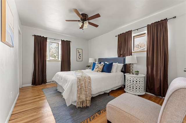 bedroom with light hardwood / wood-style flooring and ceiling fan