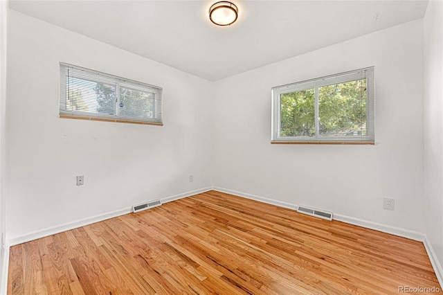 unfurnished room featuring light hardwood / wood-style floors