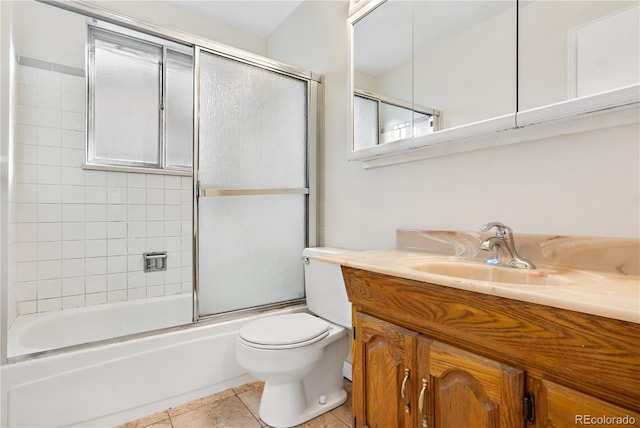 full bathroom with tile patterned floors, vanity, toilet, and enclosed tub / shower combo