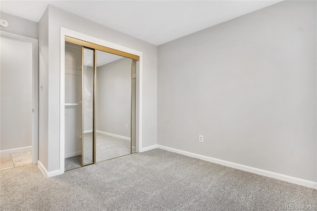 unfurnished bedroom with carpet and a closet