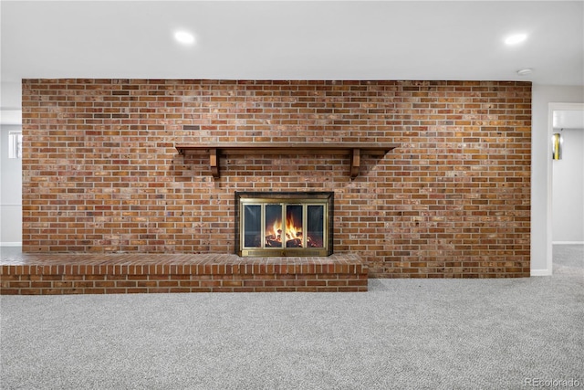 unfurnished living room with carpet and a fireplace