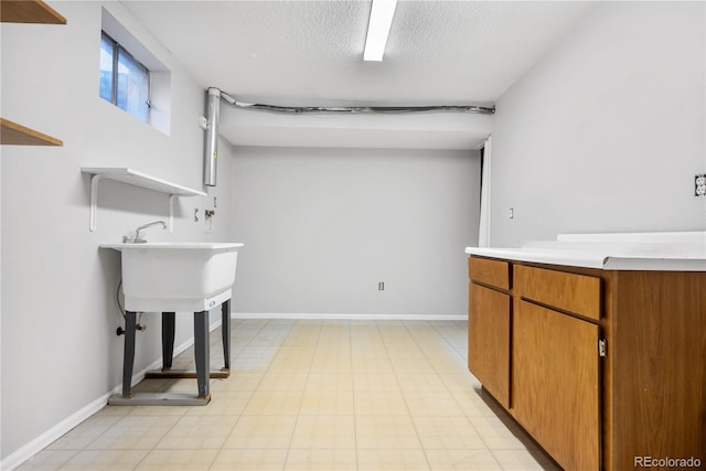 laundry area featuring a textured ceiling