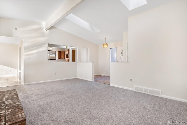 unfurnished living room featuring carpet and lofted ceiling with skylight