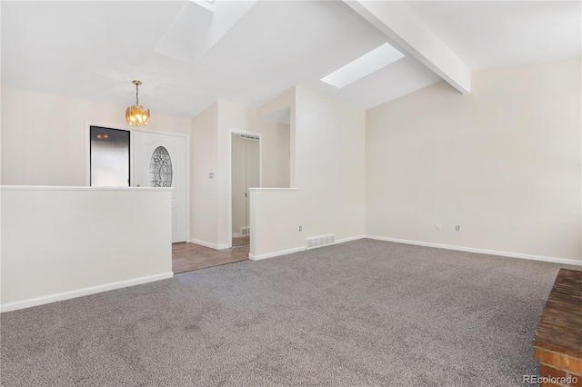 unfurnished living room featuring vaulted ceiling with skylight, carpet floors, and a chandelier