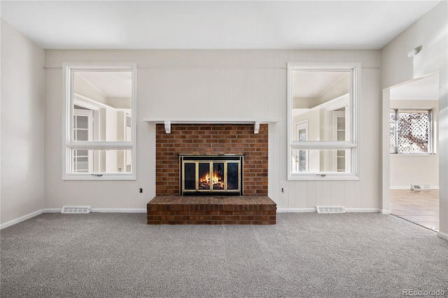 unfurnished living room with a fireplace and carpet floors