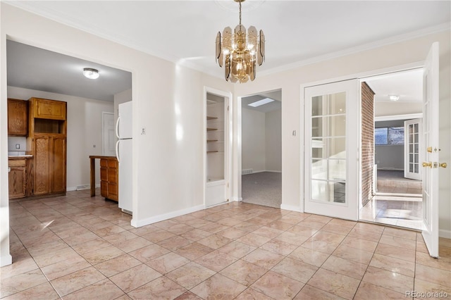 unfurnished dining area featuring french doors, ornamental molding, and a notable chandelier