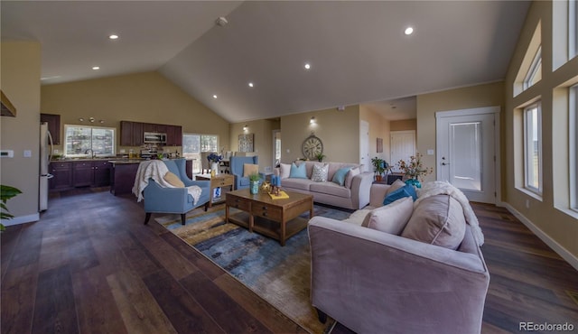 living room with high vaulted ceiling, dark hardwood / wood-style flooring, a wealth of natural light, and sink