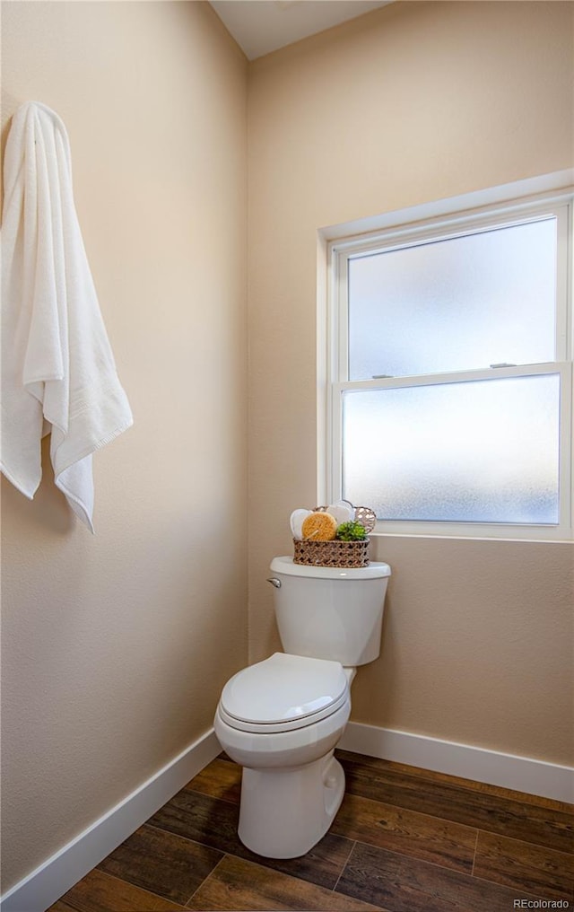 bathroom featuring wood-type flooring and toilet