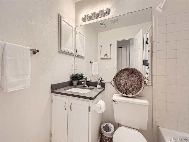 full bathroom with vanity, toilet, and tiled shower / bath combo