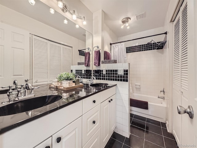 bathroom with shower / tub combo with curtain, vanity, tile patterned flooring, and tile walls